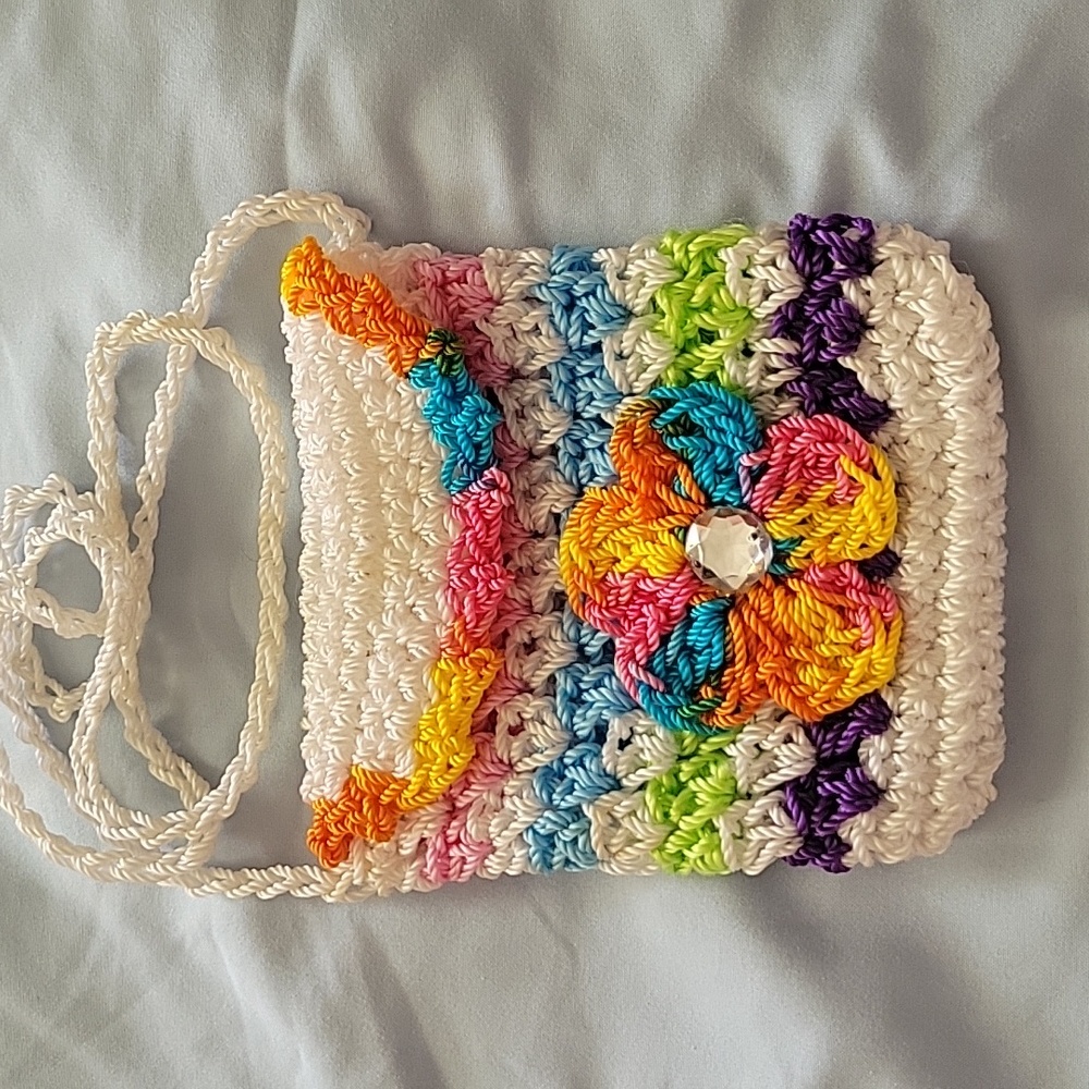 Child's crochet purse or coin purse. No tags hand made 4" by 4". Strap is 14"